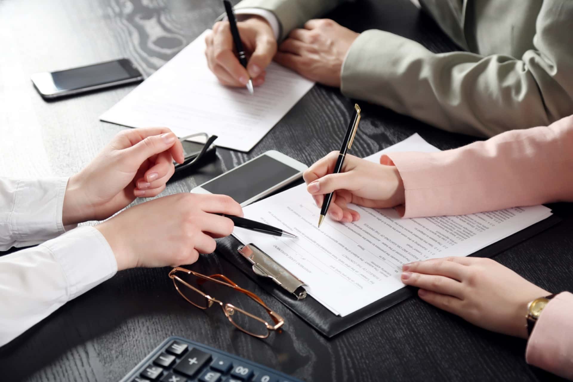 Human Hands Working With Documents At The Desk | Estate Planning Law Firm in WA​ | Legacy Law Group