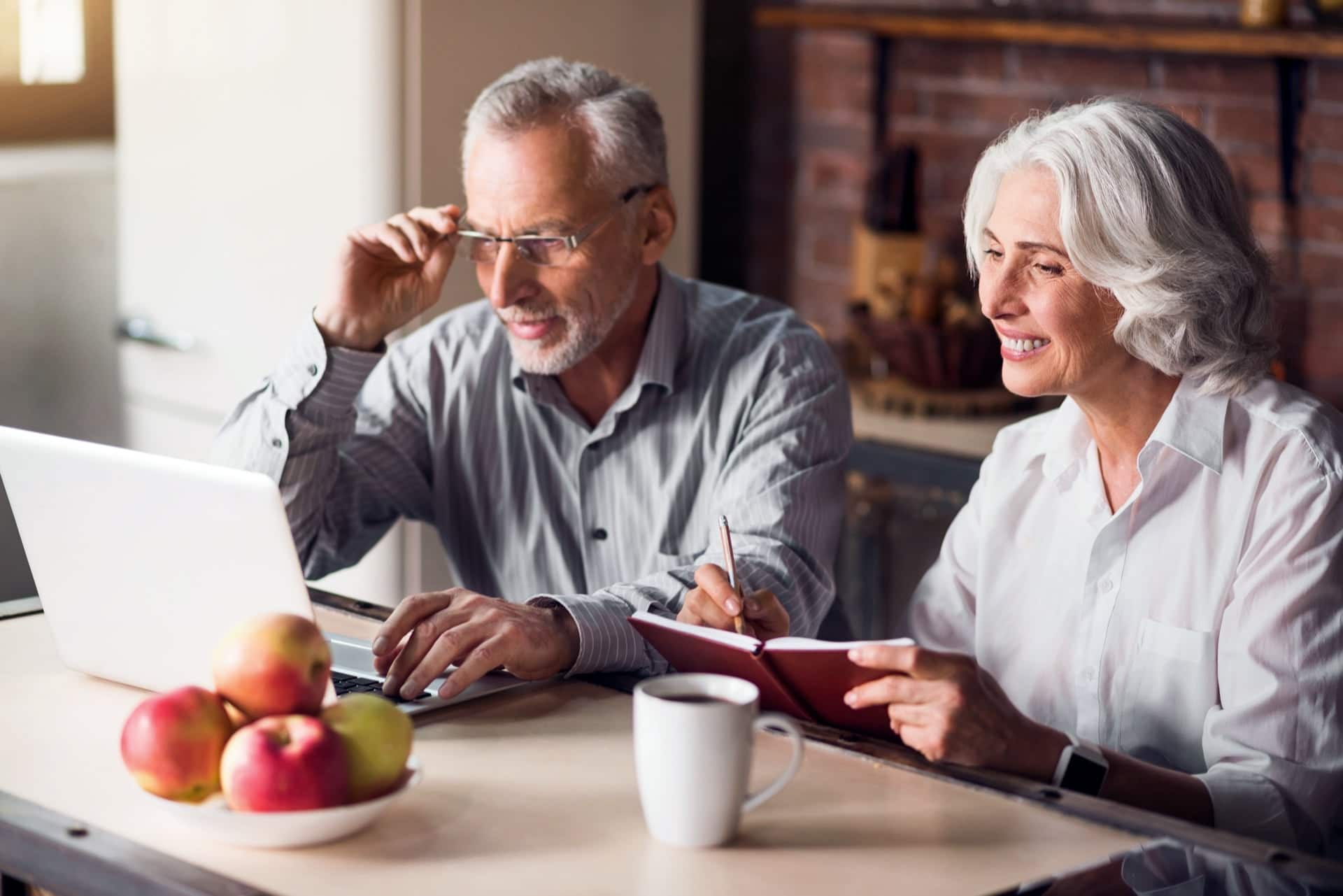 Two Elderly Couple Looking At Laptop Screen Happily | Estate Planning Law Firm​ | Legacy Law Group