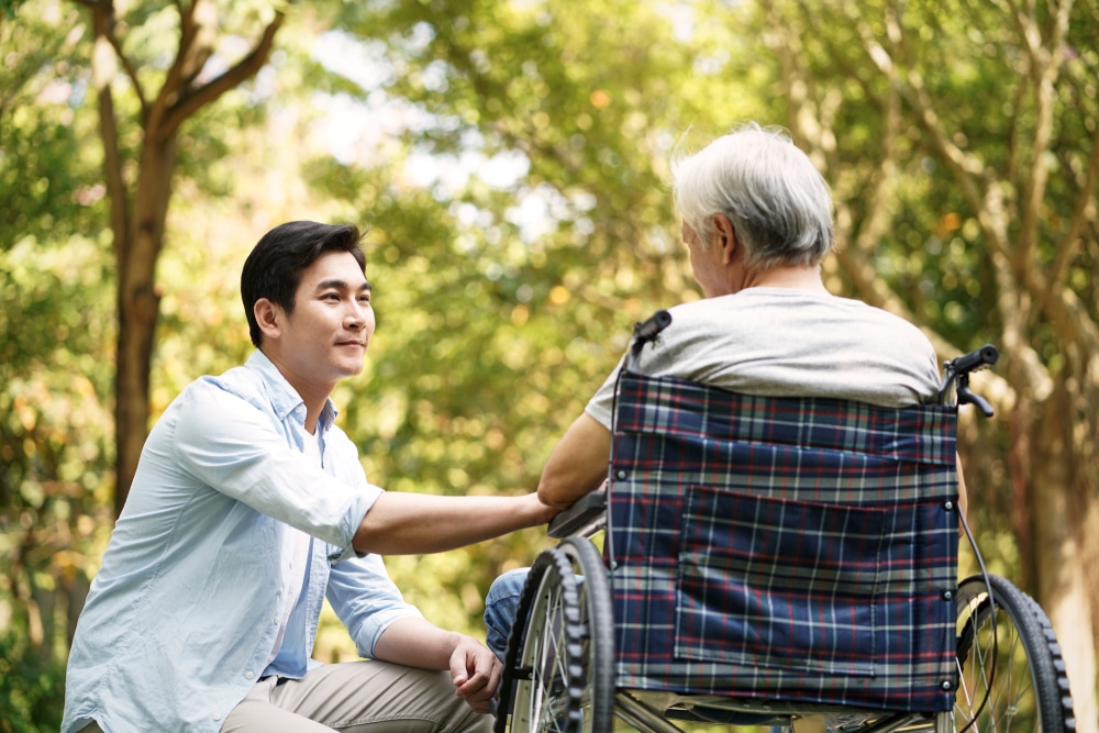 Son Comforting Father on a Wheelchair | Advance Care & Estate Planning Law Firm​ | Legacy Law Group