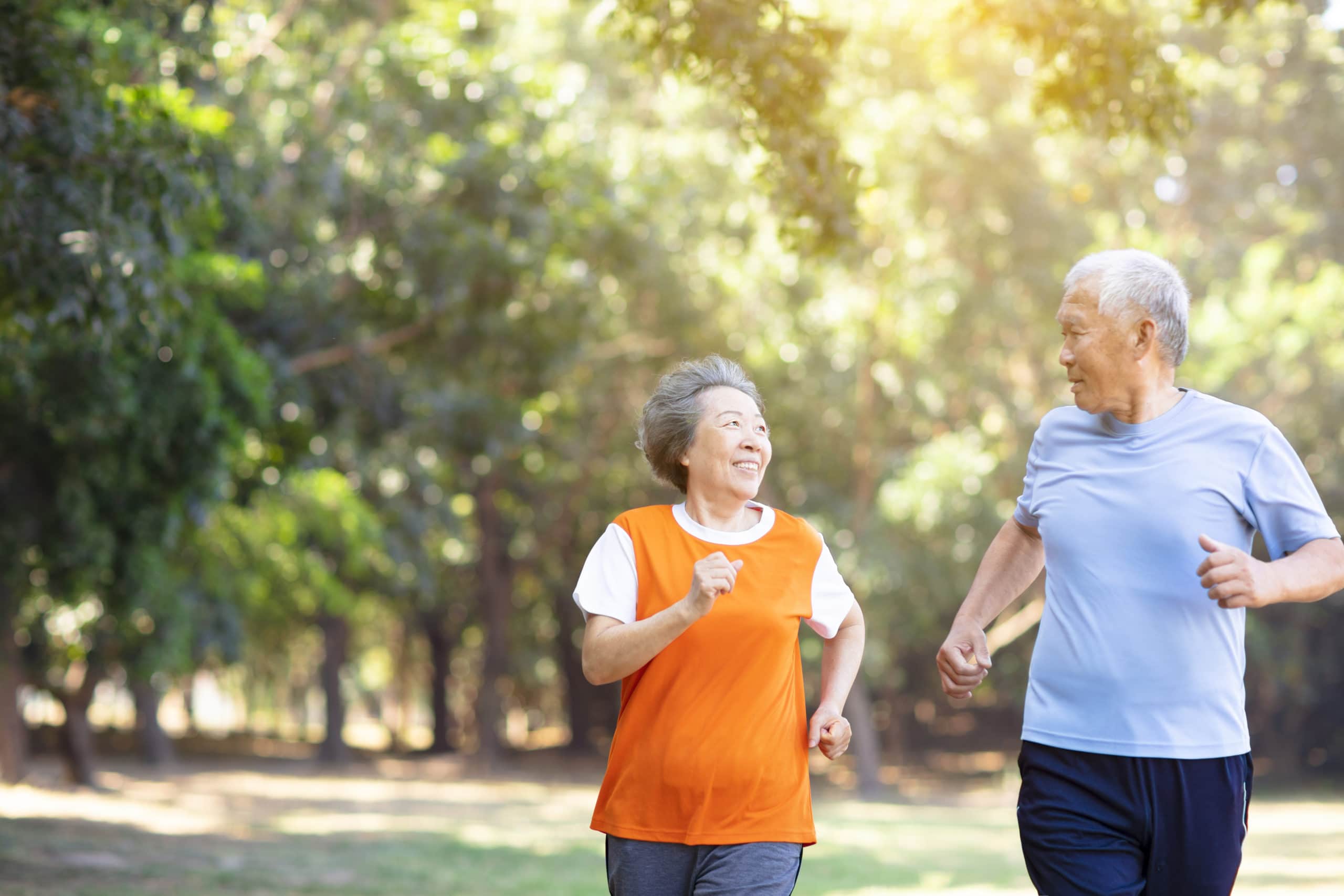Happy Senior Couple Running in the Park | Long Term Care Attorney​​ | Legacy Law Group