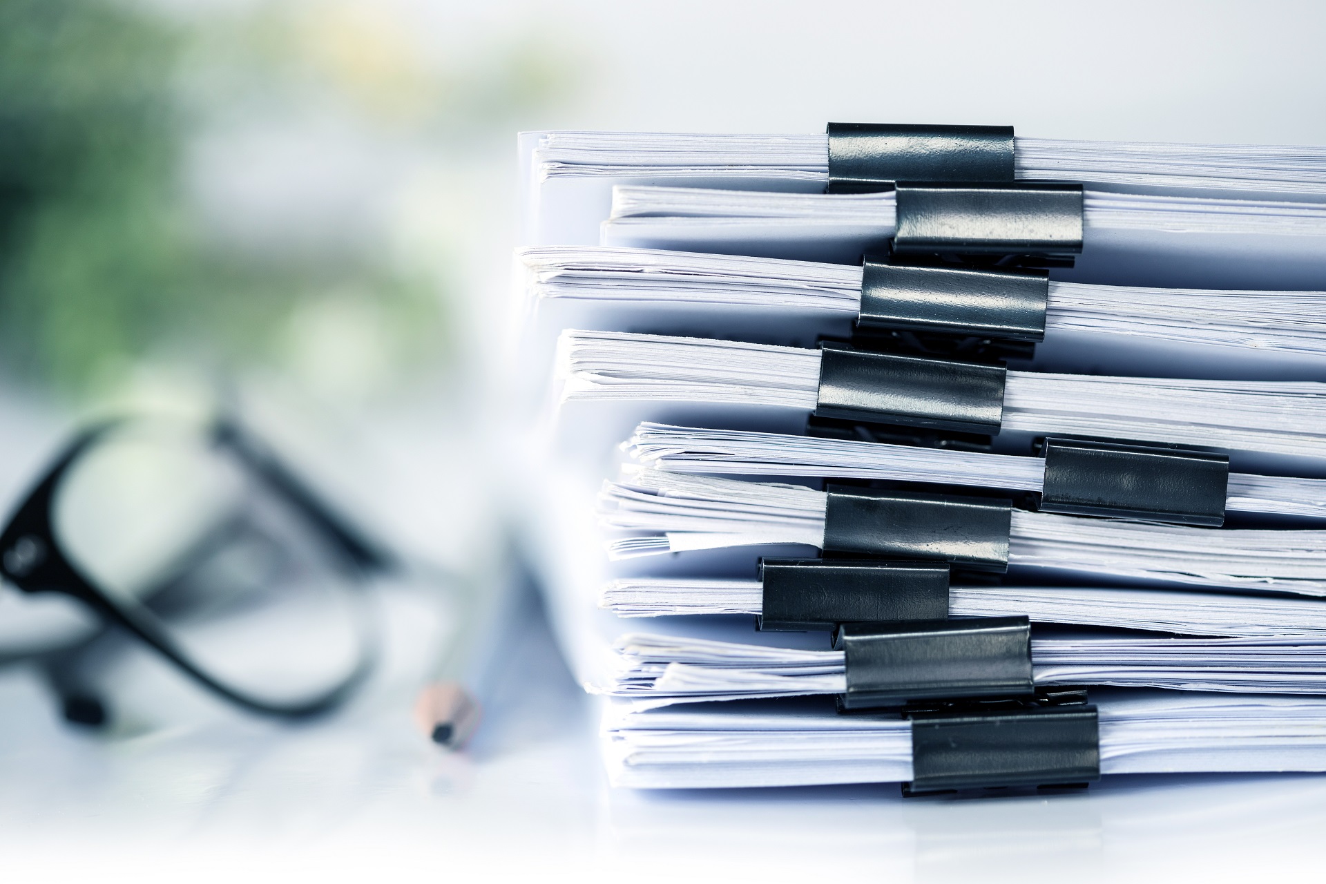 Stack Of Legal Documents With Paper Clip Folder | Long Term Care Planning​​ | Legacy Law Group