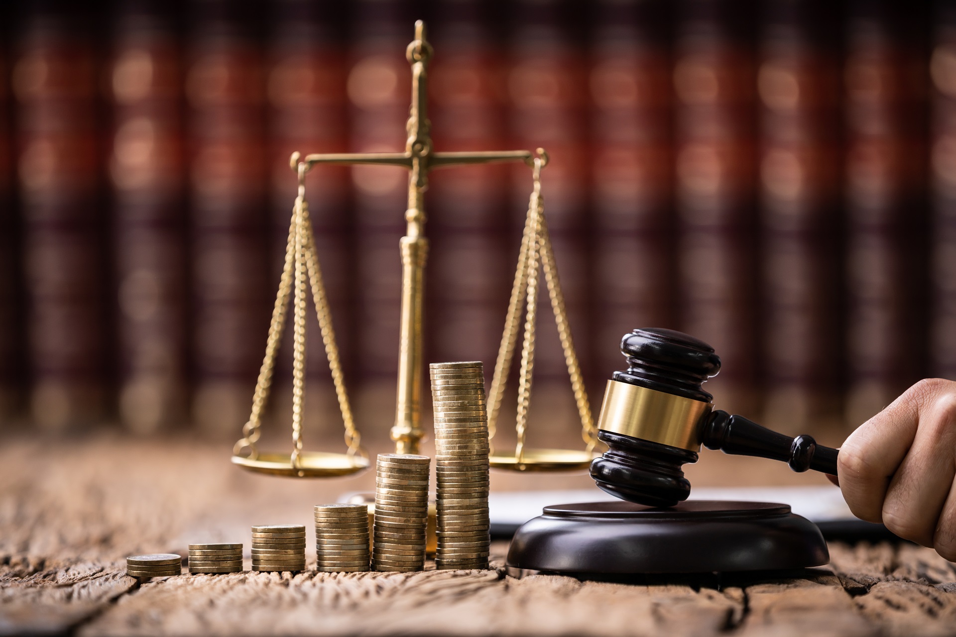 Judge Holding Mallet In Front Of Stacked Coins | Estate Planning Law Firm​ in WA | Legacy Law Group