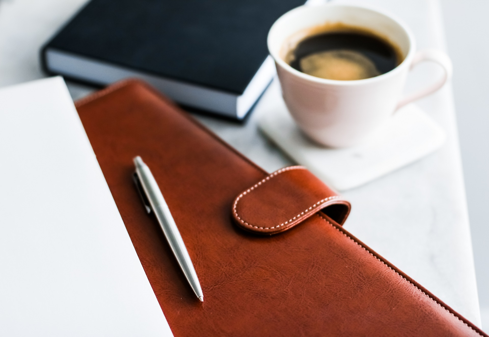 Legal Documents with Notebook and Coffee | Living Will vs Living Trust​ | Legacy Law Group