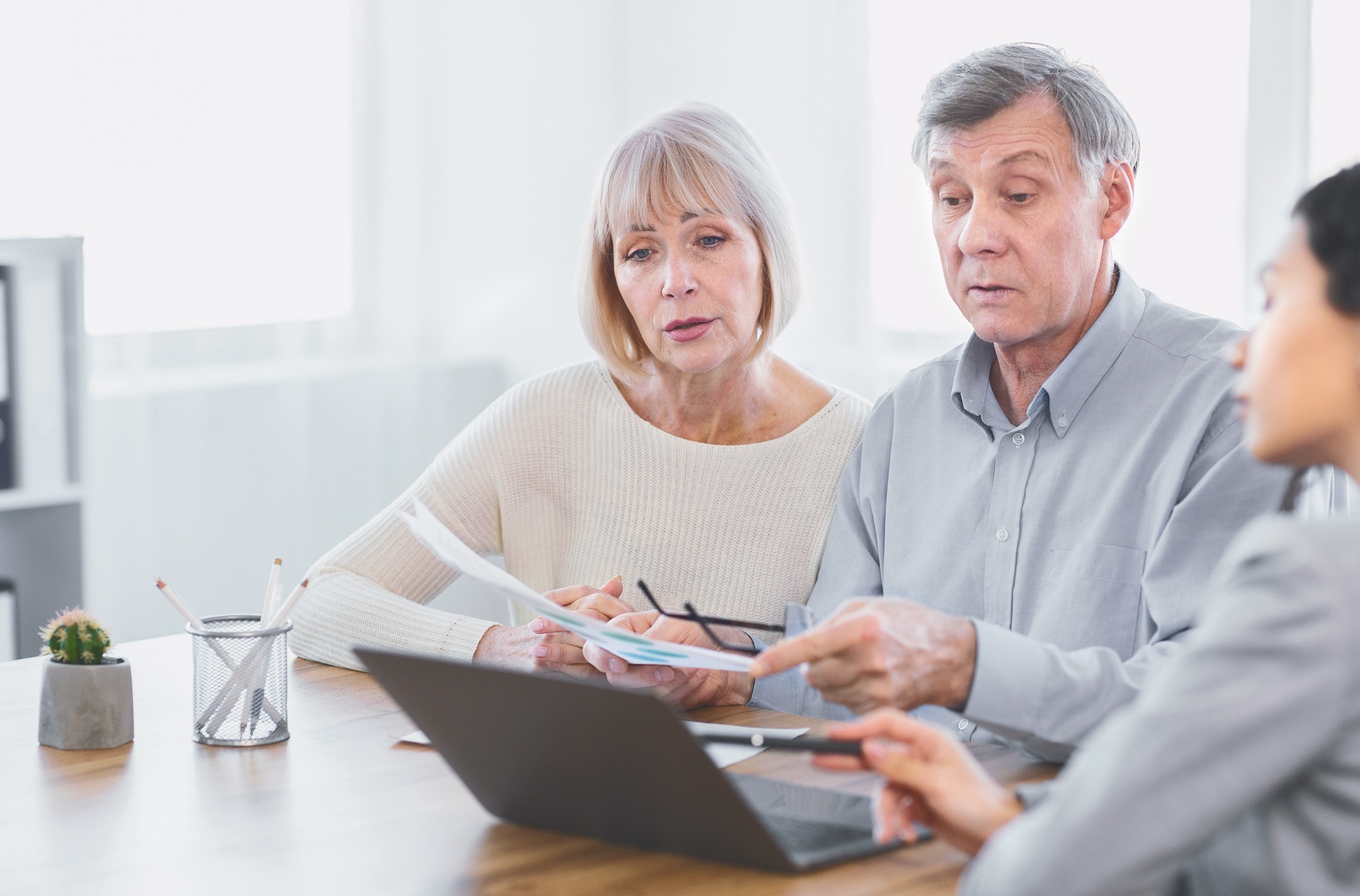 Focused Mature Couple Talking to Financial Advisor | Family Estate Planning​​ | Legacy Law Group