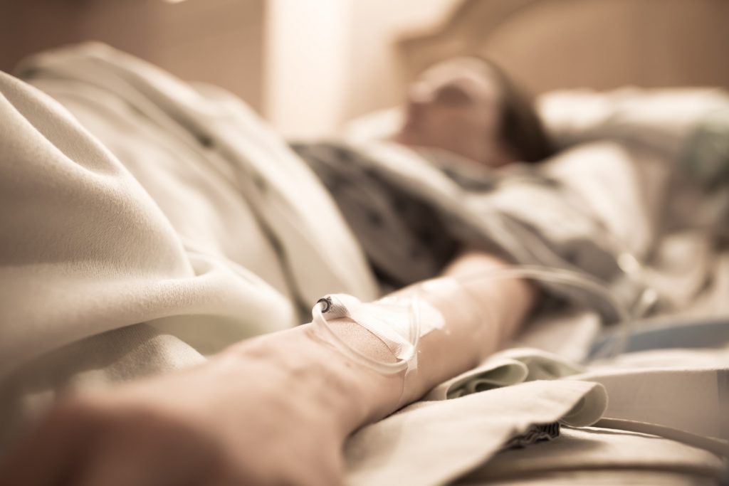 Sick Woman Lying in Hospital Bed | Estate Planning Law Firm in Washington​ | Legacy Law Group