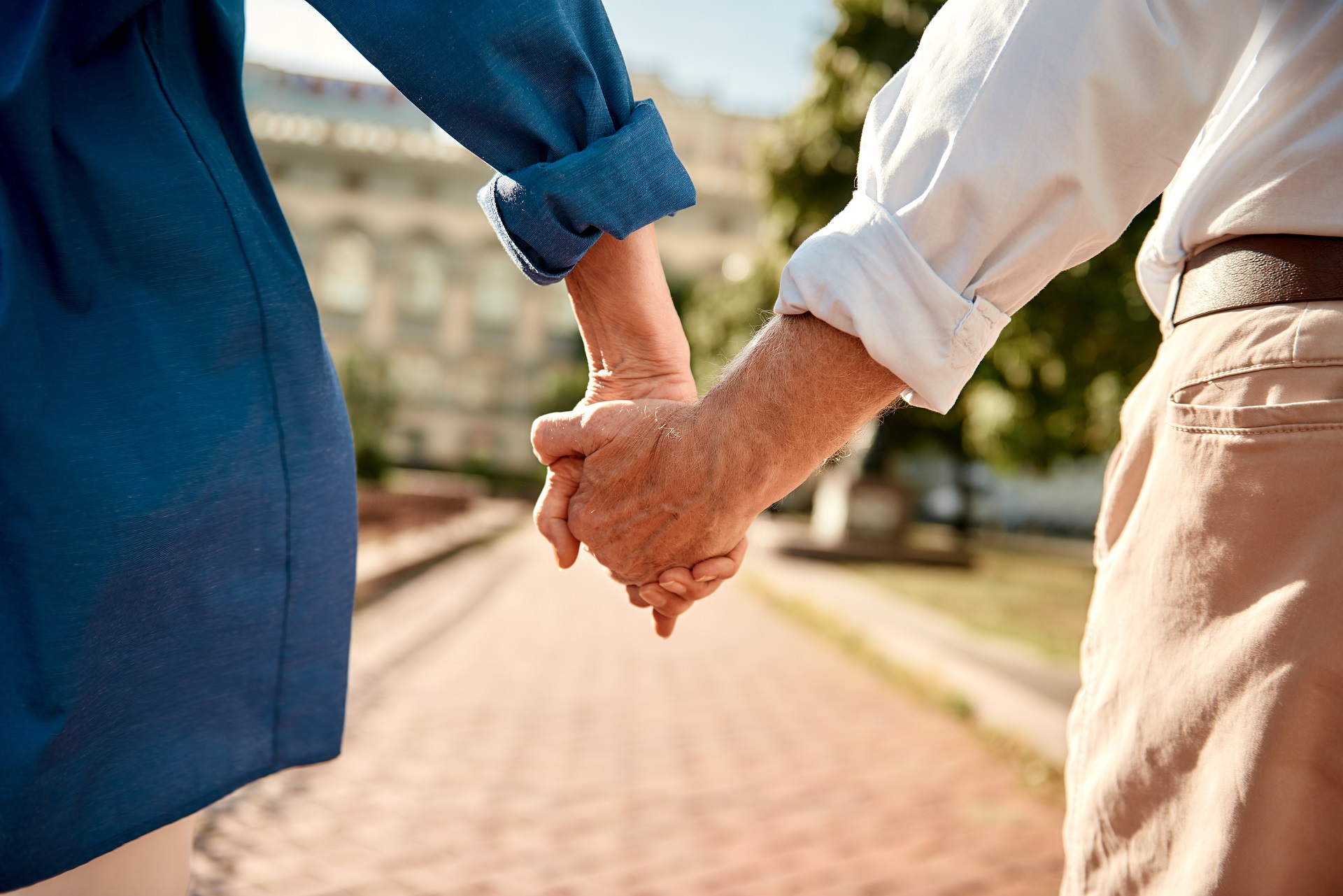 Elderly Couple Holding Hands | Family Estate Law | Long Term Care Planning​​ | Legacy Law Group