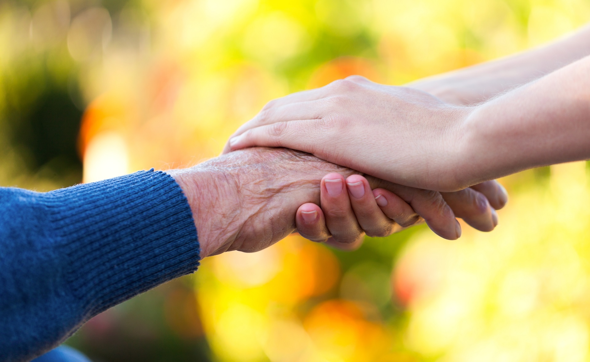 Girl Holding Hands With Elderly Man | Long Term Care Planning​​ in Washington | Legacy Law Group