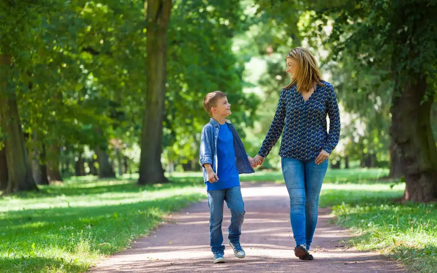 Young Woman with Son Walking Through Avenue | Probate Litigation Attorneys​​ | Legacy Law Group