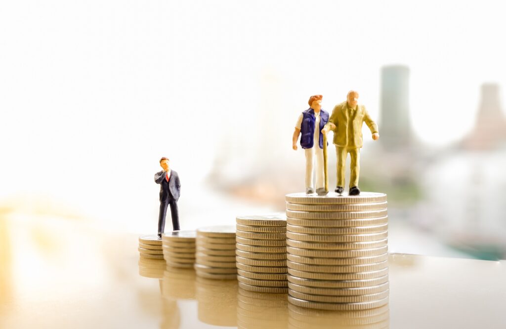 Miniature figures on ascending coin stacks | estate planning attorney​ | Legacy Law Group