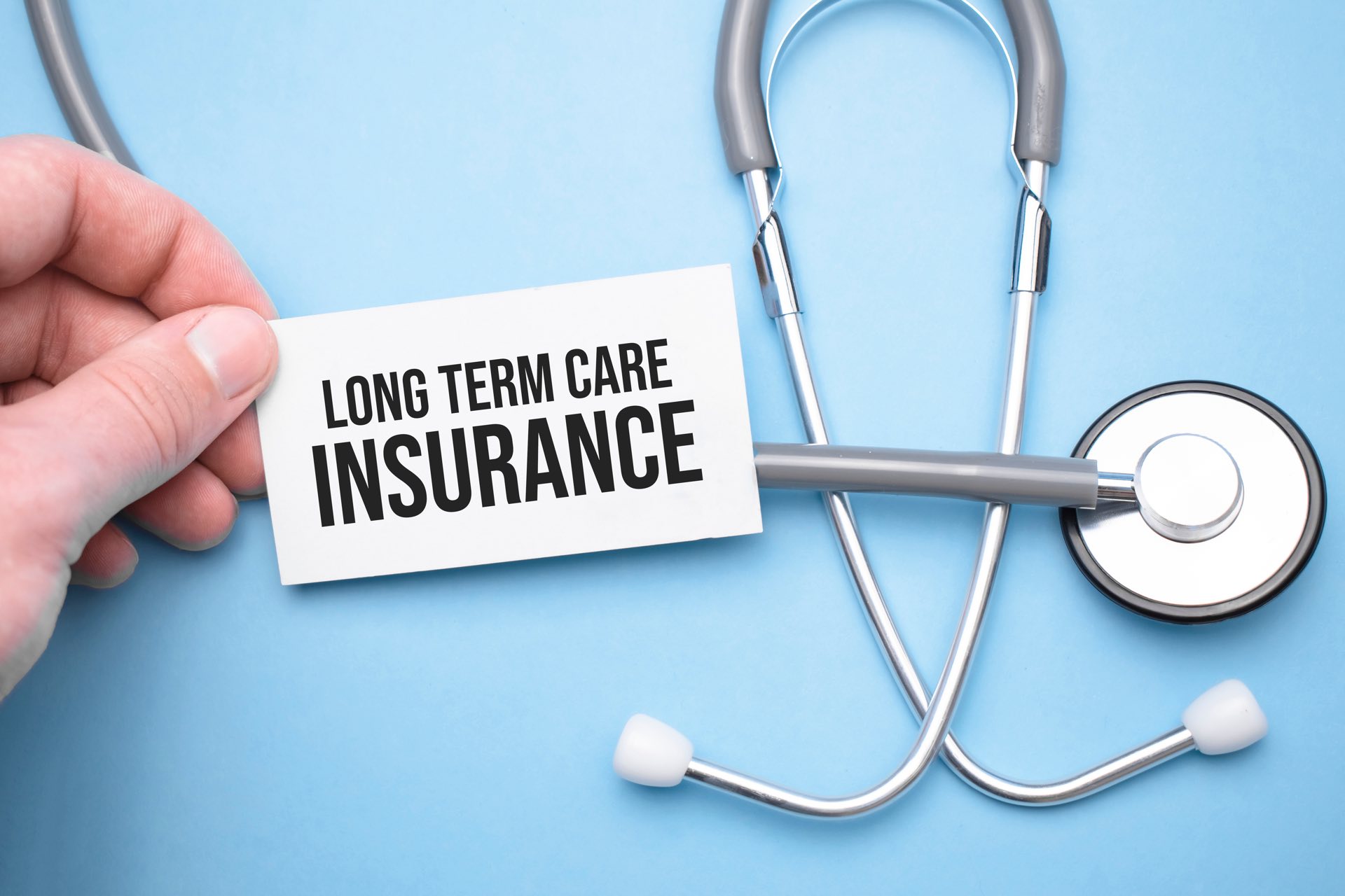 Card with 'LONG TERM CARE INSURANCE' and stethoscope | medicaid planning​ | Legacy Law Group