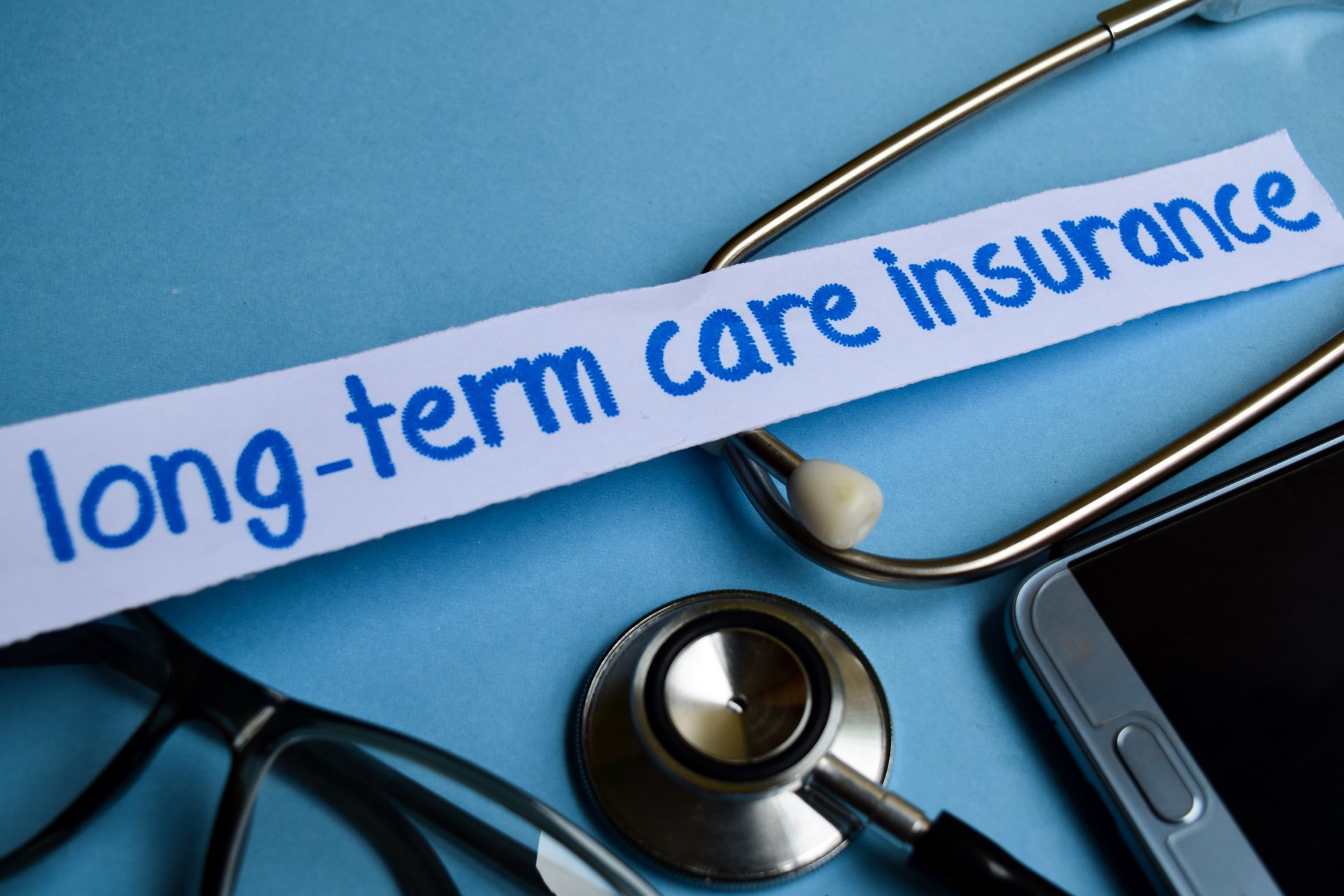 Paper strip with "long-term care insurance" text | medicaid planning​ | Legacy Law Group