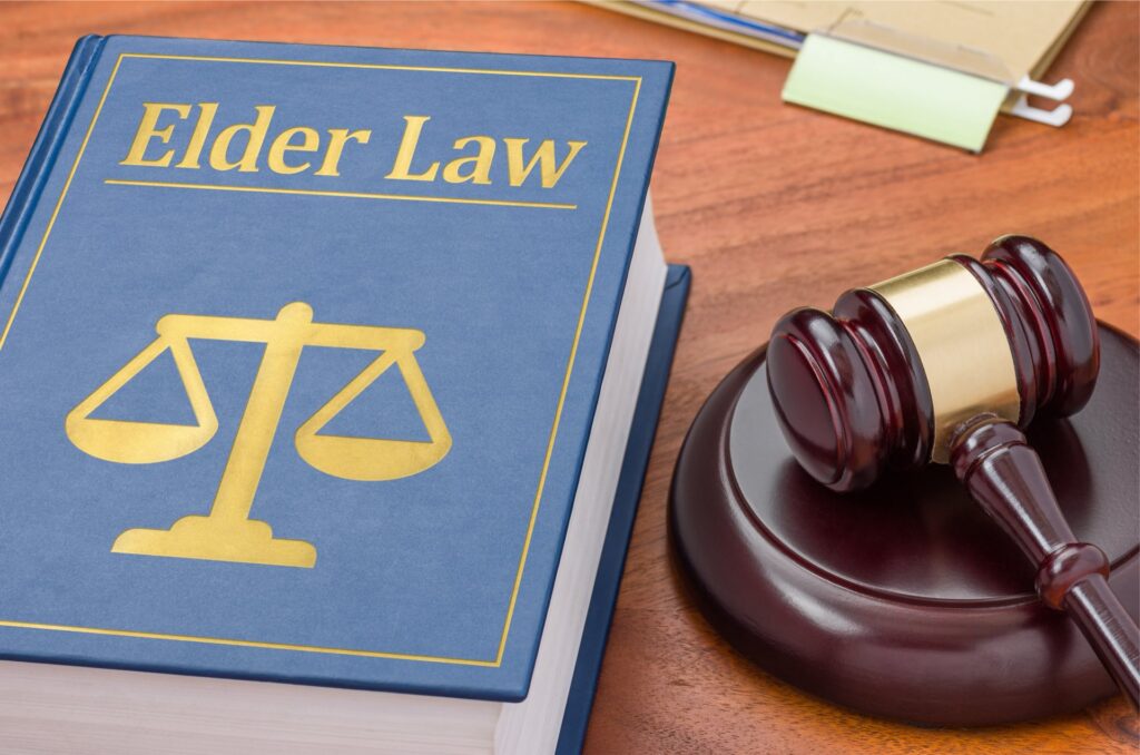 A book titled "Elder Law" next to a wooden gavel on a desk | medicaid trusts​ | Legacy Law Group